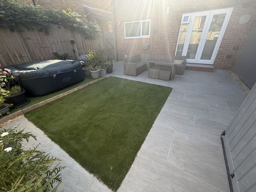 Artificial lawn with porcelain paving surround